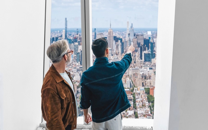 Visitors enjoying the New York City skyline from One World Observatory.