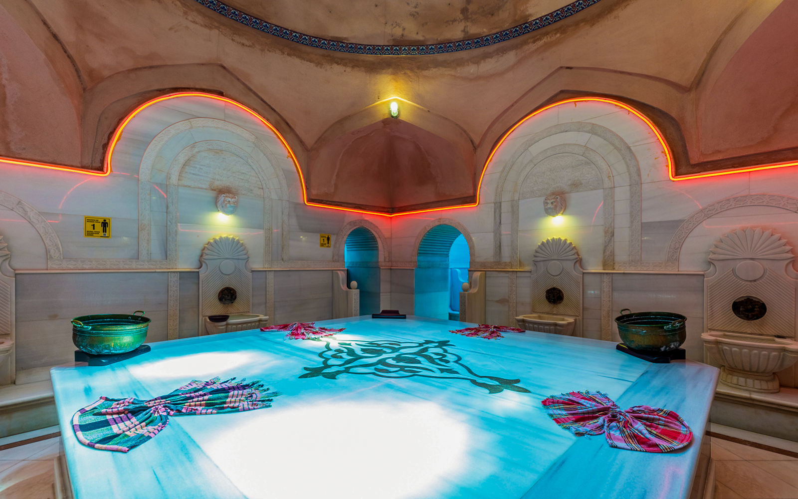 Traditional Turkish hammam bath interior in Istanbul, Turkey, with marble basins and ornate tiles.
