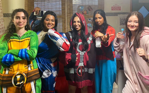 Participants in superhero costumes at Asakusa Street Go-Kart Experience.