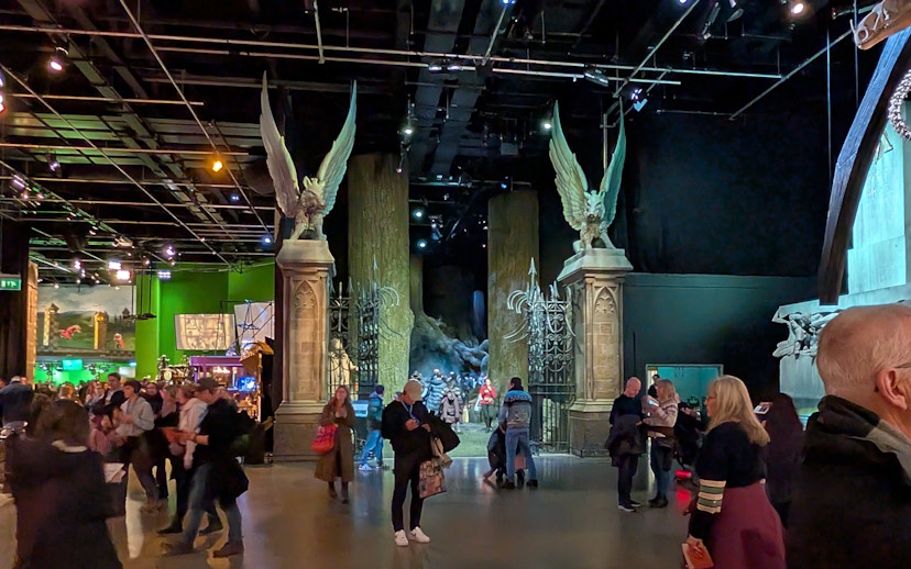 Visitors exploring the Hogwarts Great Hall set at Warner Bros. Studio Tour London.