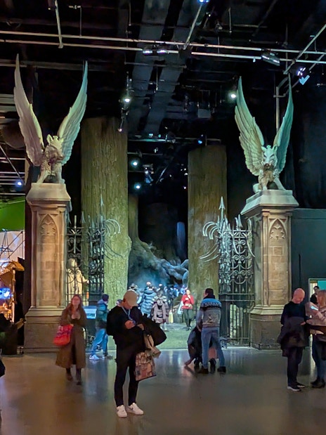 Visitors exploring the Hogwarts Great Hall set at Warner Bros. Studio Tour London.