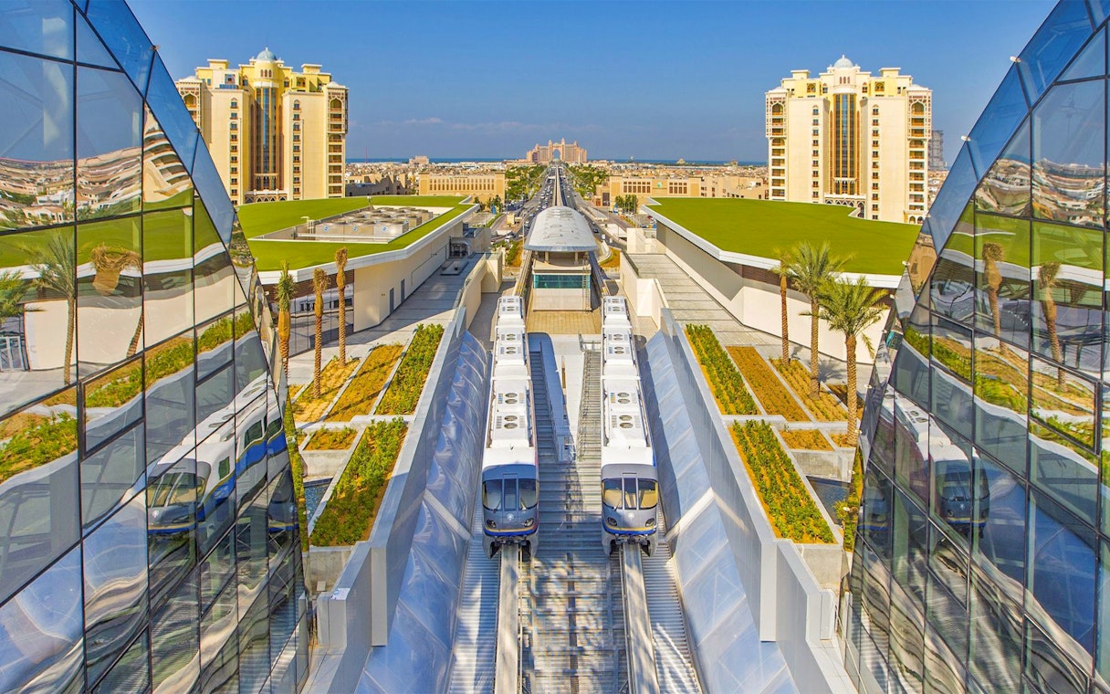 Palm Jumeirah Monorail near station with modern architecture and cityscape.