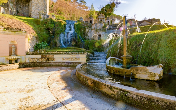 Villa D'Este fountains and gardens in Tivoli, Italy, featuring cascading waterfalls and ornate sculptures.