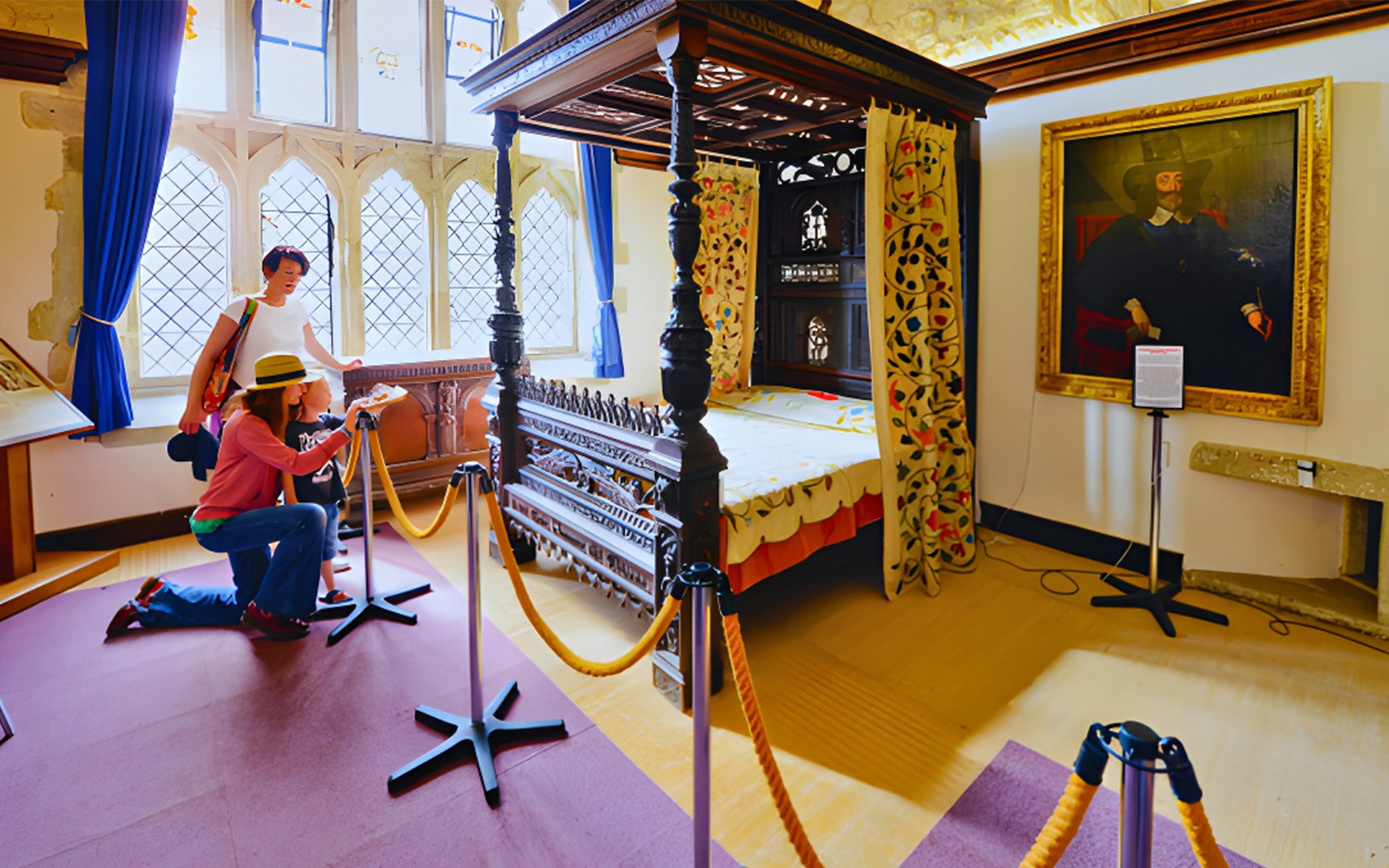 Visitors exploring a historic bedroom exhibit with a canopy bed and portrait in a museum.