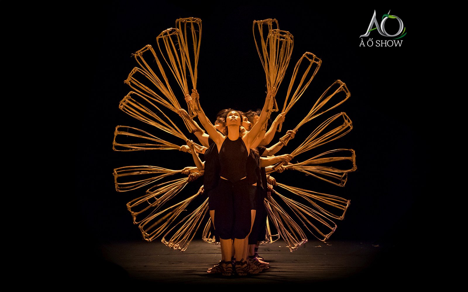 Women performing with bamboo props at AO Show.