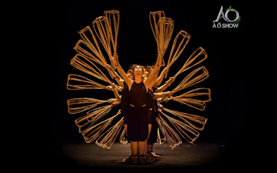 Women performing with bamboo props at AO Show.