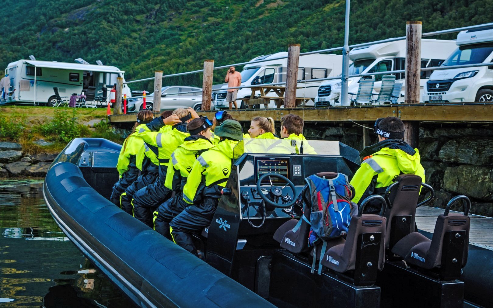 People in bright jackets seated on a RIB boat for a fjord safari in Geiranger.