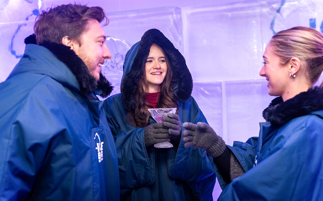Visitors in winter coats enjoying drinks at IceBar Surfers Paradise.
