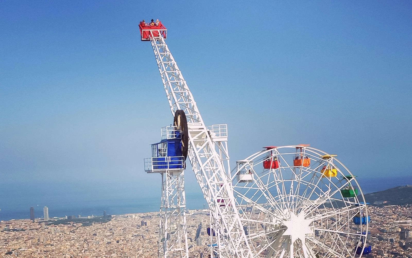 Tibidabo Amusement Park rides and attractions with panoramic views of Barcelona, Spain.