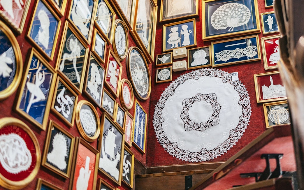 Lace exhibits displayed in frames at the Lace Museum in Burano.
