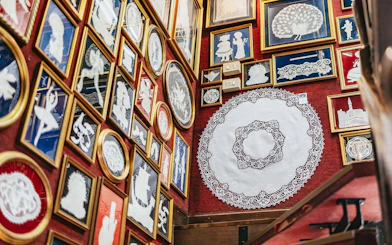 Lace exhibits displayed in frames at the Lace Museum in Burano.