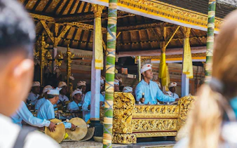 Musicians performing traditional music at Mengening Temple, Bali, during a purification ceremony.