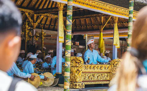 Musicians performing traditional music at Mengening Temple, Bali, during a purification ceremony.