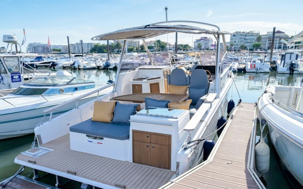 Excursion boats docked in Calanques de Cassis marina, ready for tours.