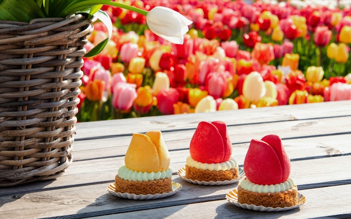 Tulip-shaped pastries on a wooden table at Tulip Experience Amsterdam.