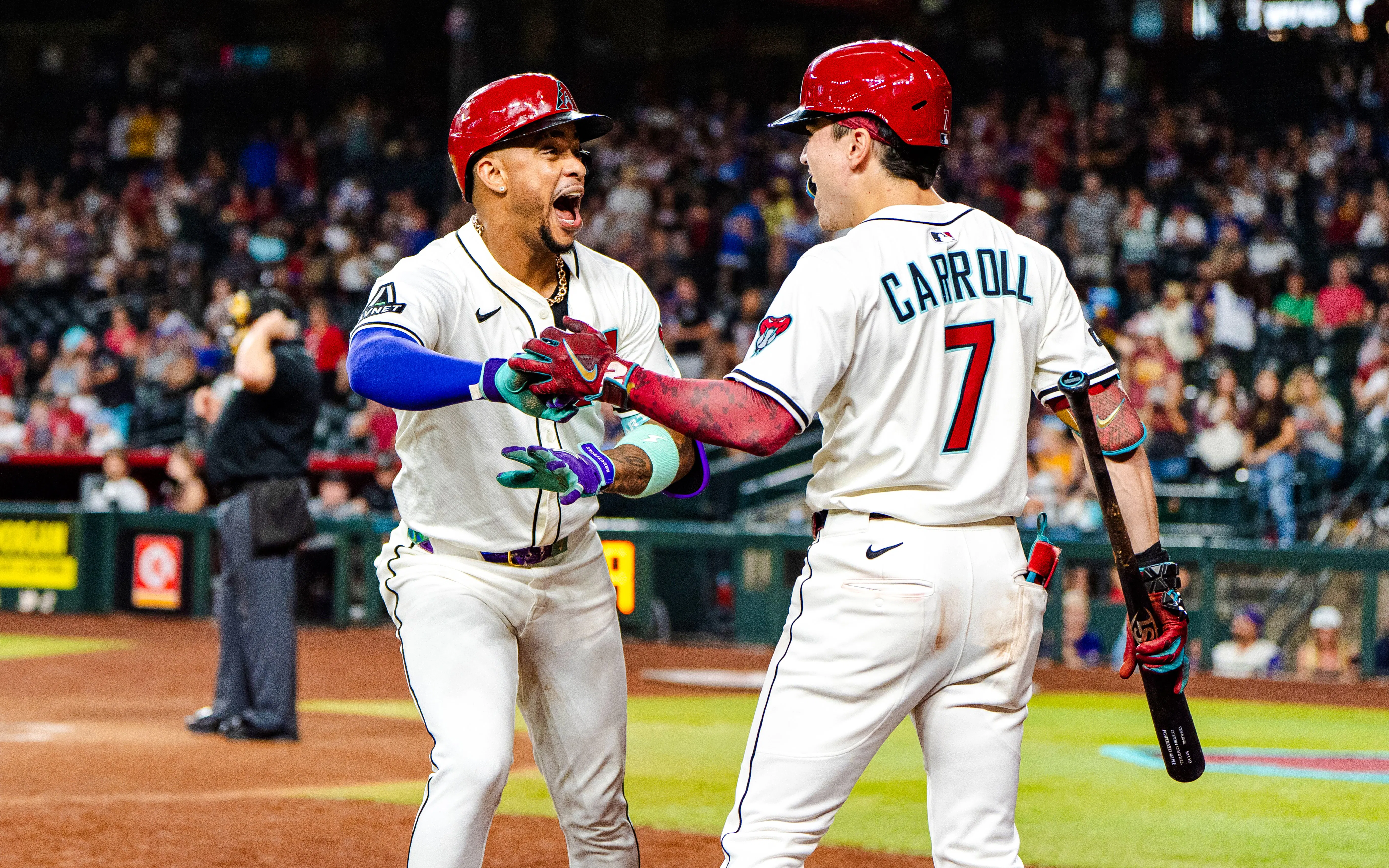 Arizona Diamondbacks players celebrating on the field during a game.
