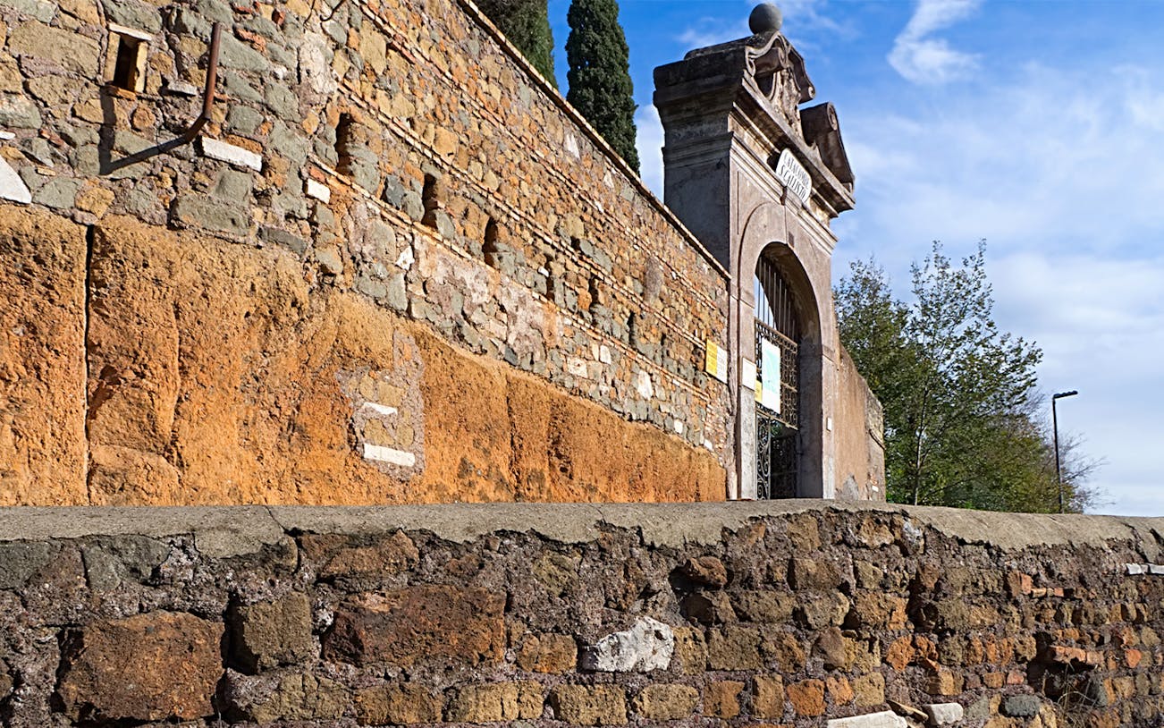 Entrance to the Catacombs of St. Callixtus in Rome, featuring ancient stone walls.
