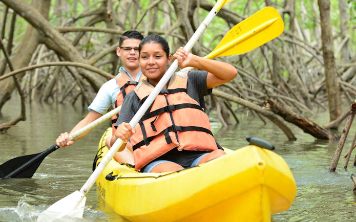 Kayakers navigating mangrove estuary on Damas Island tour from Manuel Antonio.