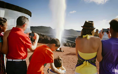 Tourists watching a geothermal demonstration at Timanfaya National Park, Lanzarote.