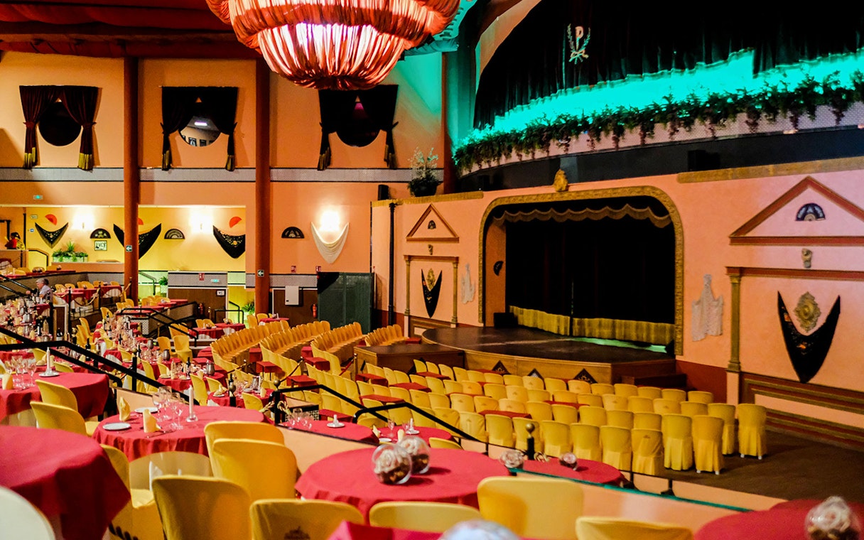 Stage area set for a Flamenco show at El Palacio Andaluz, with tables and chairs arranged for guests.