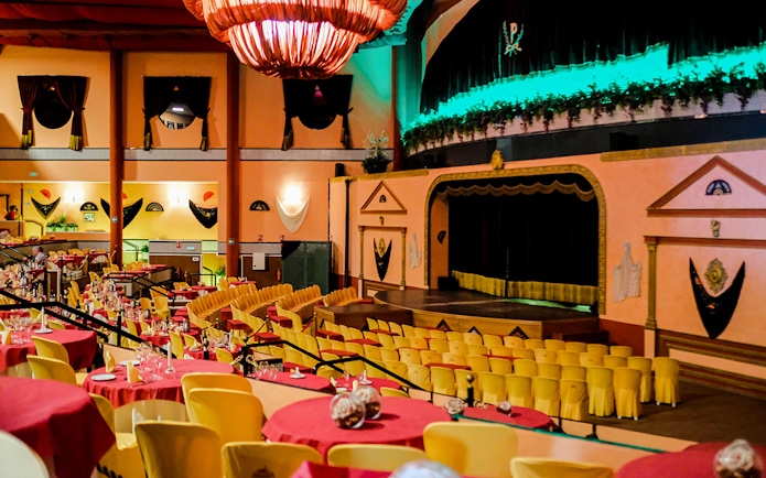 Stage area set for a Flamenco show at El Palacio Andaluz, with tables and chairs arranged for guests.