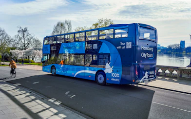 Hop-On Hop-Off bus on Hamburg city tour near Alster Lake.