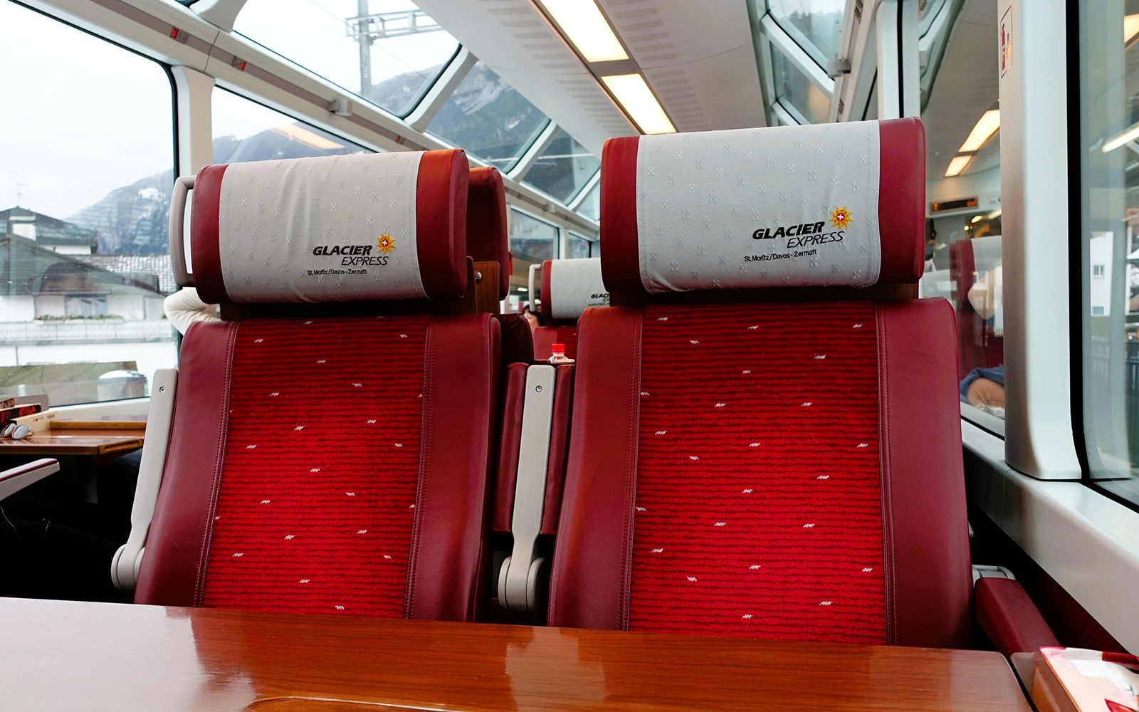 Two second class adjacent to each other, clicked from the other end of the table inside the Swiss Glacier Express