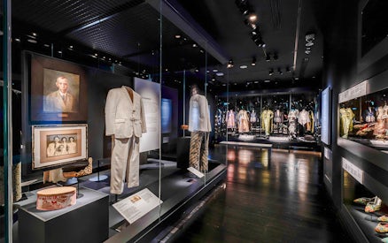 Peranakan Museum gallery showcasing traditional clothing and historical portraits.