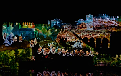Projection of historical scenes on Toledo's ancient walls during "El Sueño de Toledo" show.