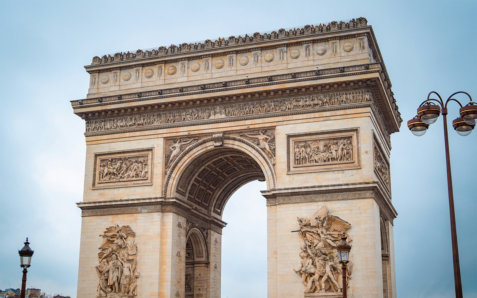 Arc de Triomphe rooftop view overlooking Paris cityscape.