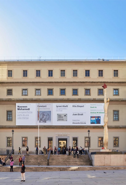 Reina Sofia Museum entrance with visitors and modern art banners, Madrid.