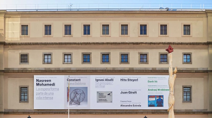 Reina Sofia Museum entrance with visitors and modern art banners, Madrid.