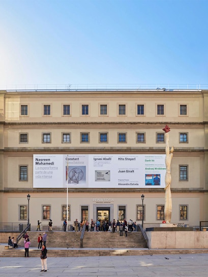Reina Sofia Museum entrance with visitors and modern art banners, Madrid.