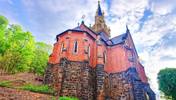 Anglican Church of St. Luke in Prague with red brick and stone architecture.