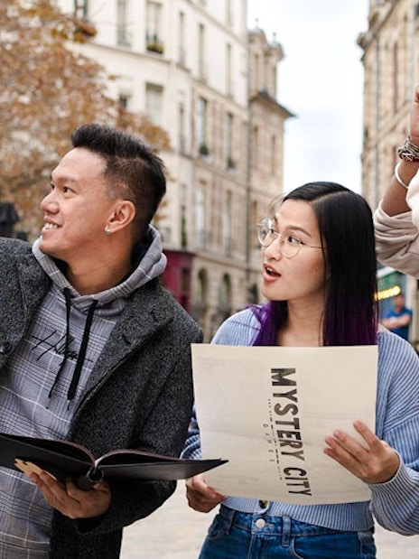 Group exploring Prague with Mystery City Games map.