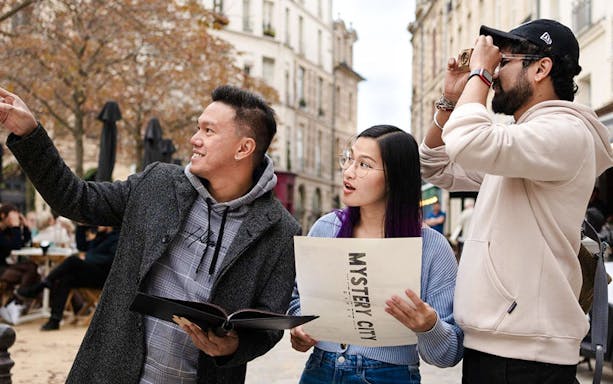 Group exploring Prague with Mystery City Games map.