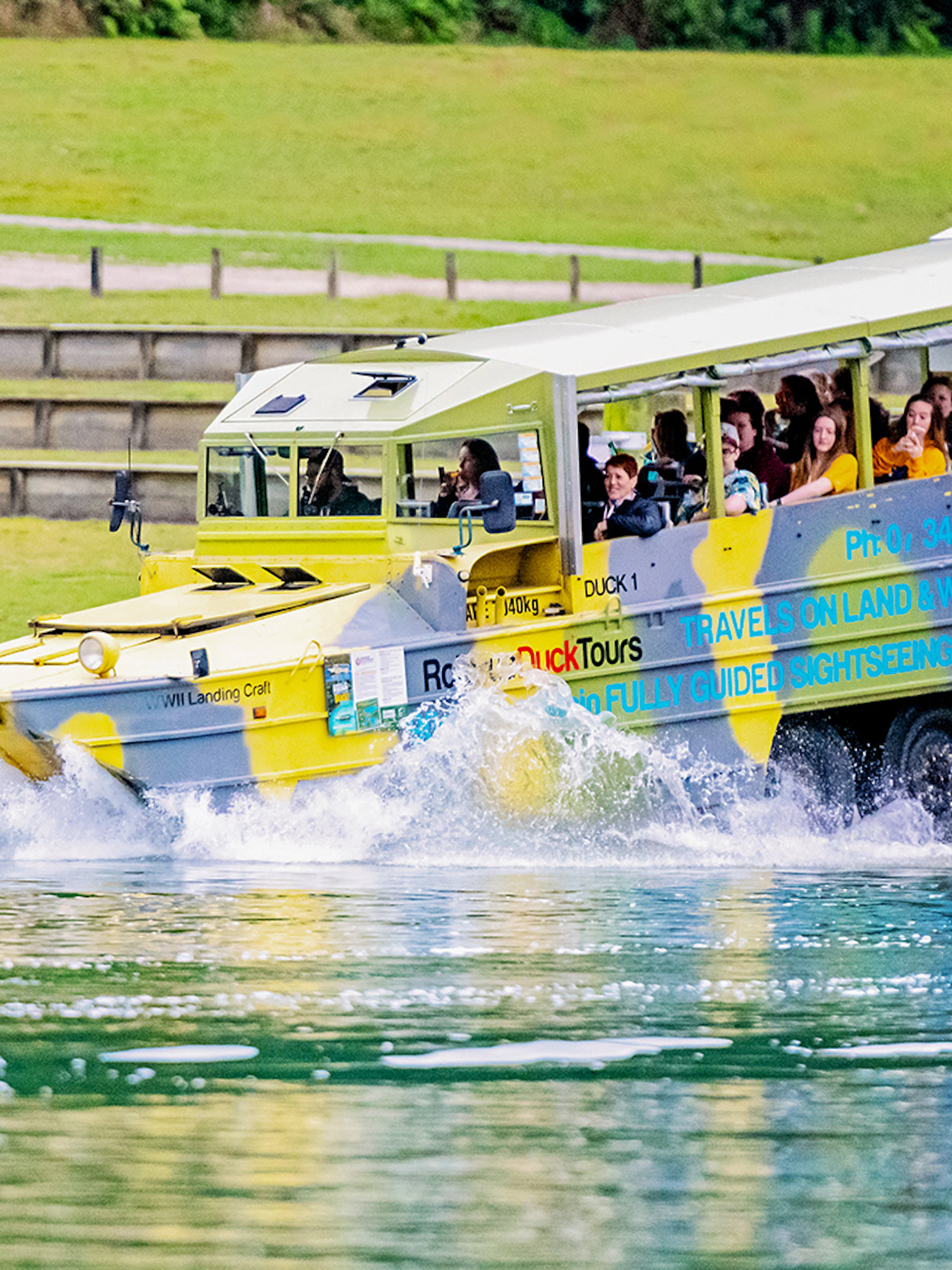 Amphibious tour vehicle entering water during Rotorua City & Lakes Tour.