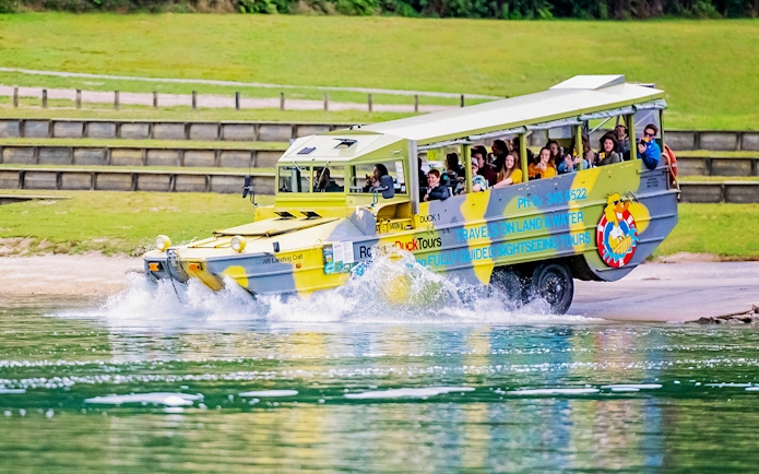 Amphibious tour vehicle entering water during Rotorua City & Lakes Tour.