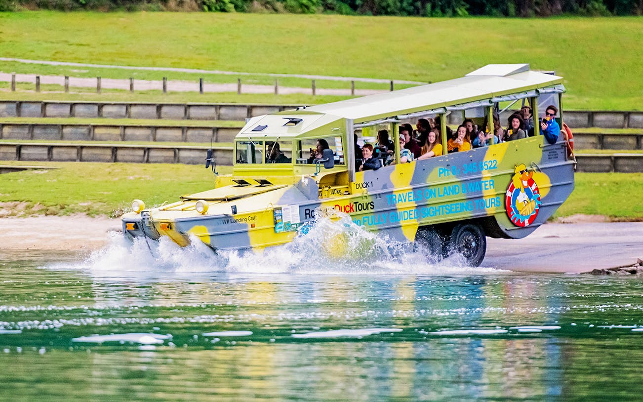 Amphibious tour vehicle entering water during Rotorua City & Lakes Tour.