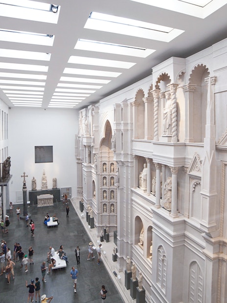 Interior of Opera del Duomo Museum, Pisa, showcasing sculptures and architectural details.