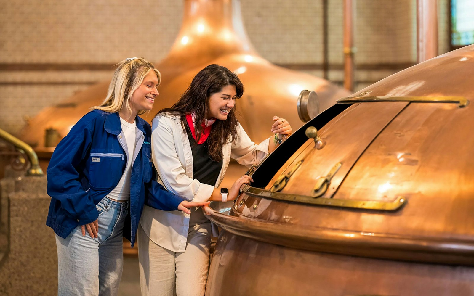 Visitors exploring interactive exhibits at the Heineken Experience in Amsterdam.