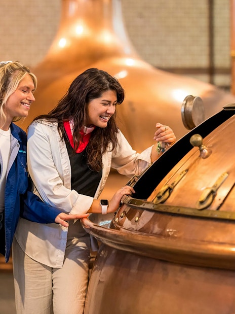 Guests exploring brewing equipment at the Heineken Experience.