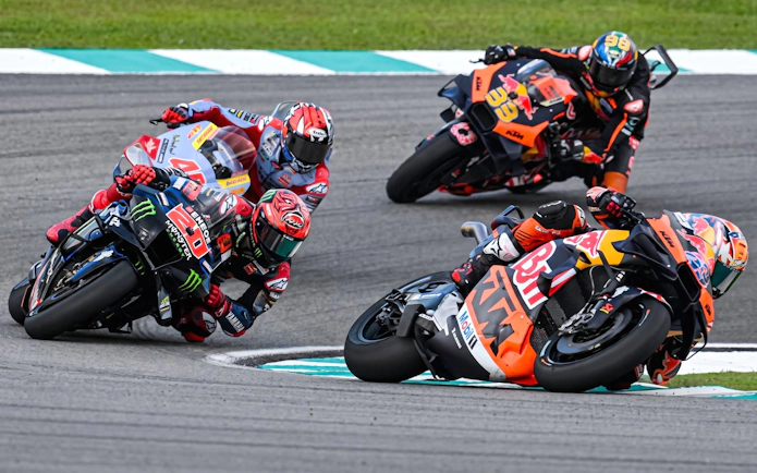 Motorcycle racers taking a sharp turn at Sepang International Circuit, Malaysia Grand Prix.