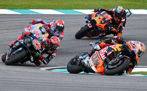 Motorcycle racers taking a sharp turn at Sepang International Circuit, Malaysia Grand Prix.