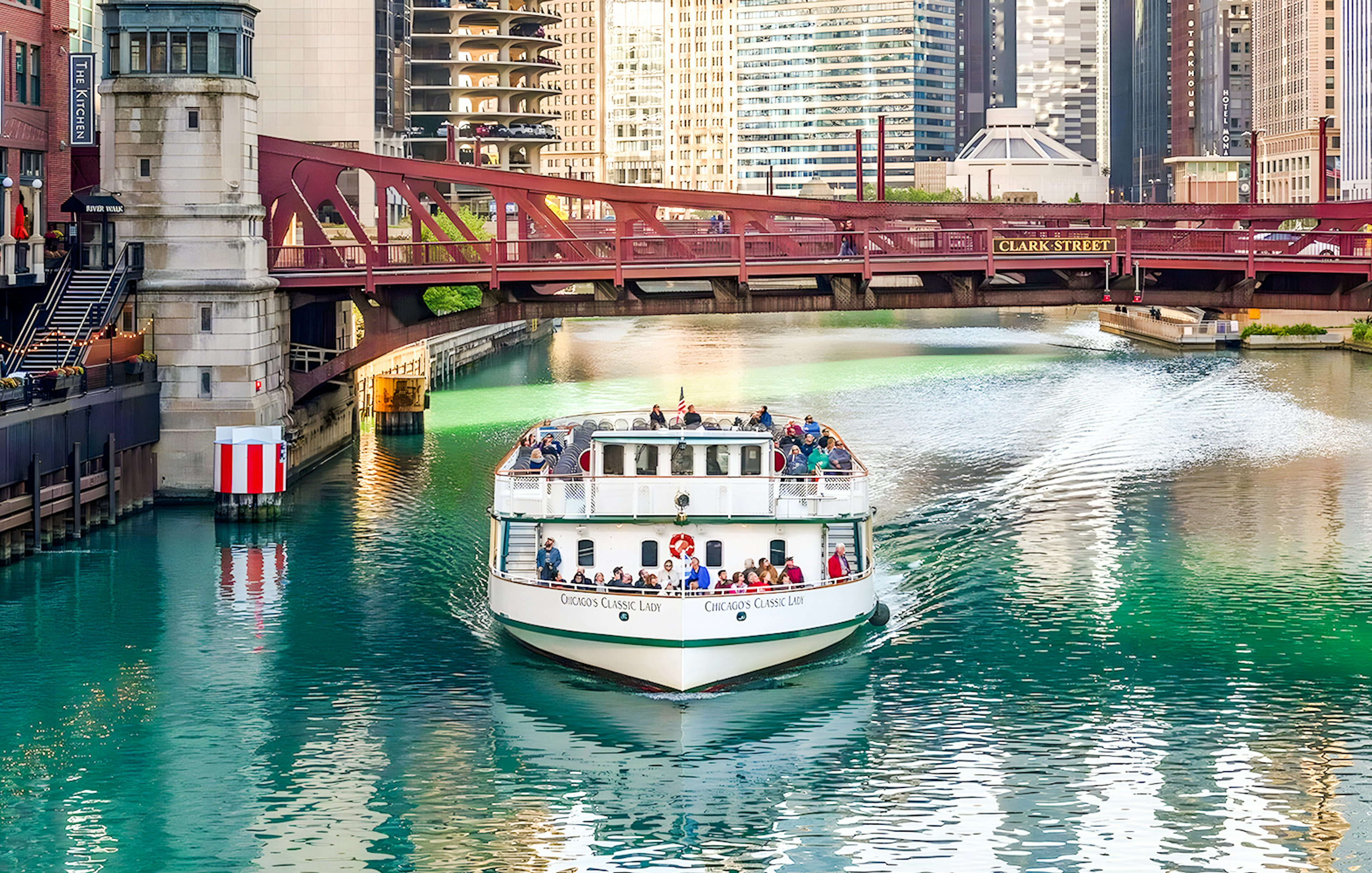 Cruise boat on Chicago River passing under Clark Street Bridge.