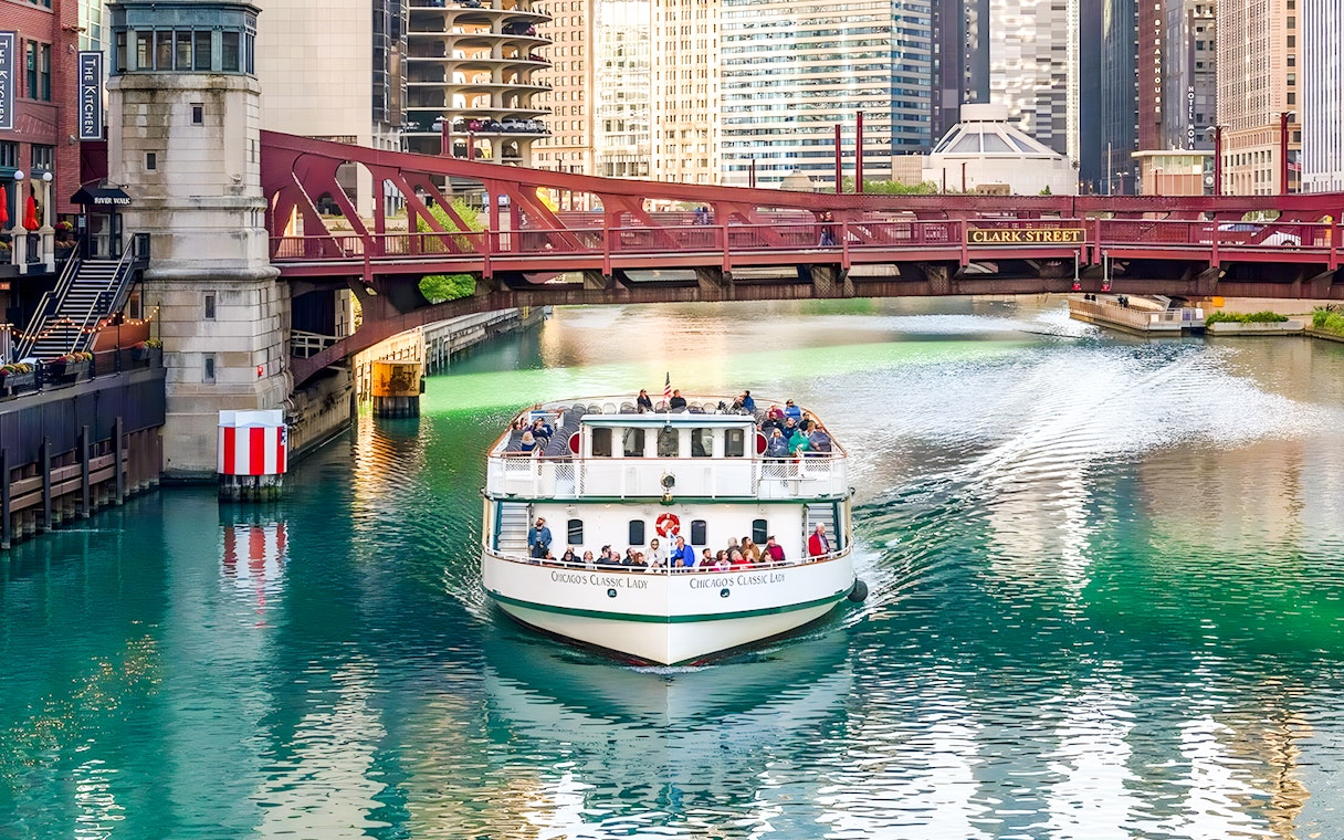 Cruise boat on Chicago River passing under Clark Street Bridge.