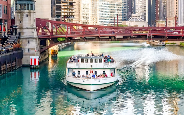 Cruise boat on Chicago River passing under Clark Street Bridge.