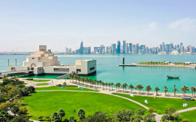 Museum of Islamic Art in Doha with city skyline and waterfront view.