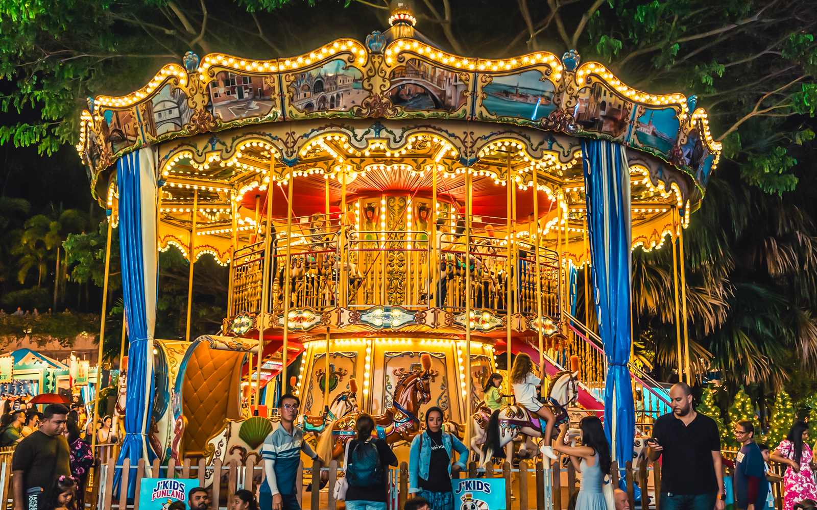 Children enjoying a carousel ride at Gardens by the Bay Christmas carnival.