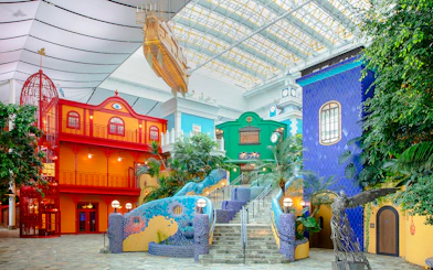 Colorful buildings and sculptures inside Ghibli Park's Grand Warehouse, Japan.
